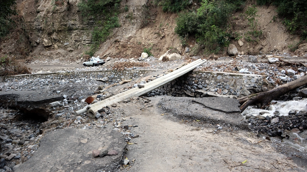 Puentes peatonales improvisados con postes de luz y árboles caídos
