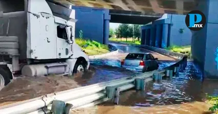 Conductor lucha contra el agua tras quedar atrapado en el Periférico Ecológico